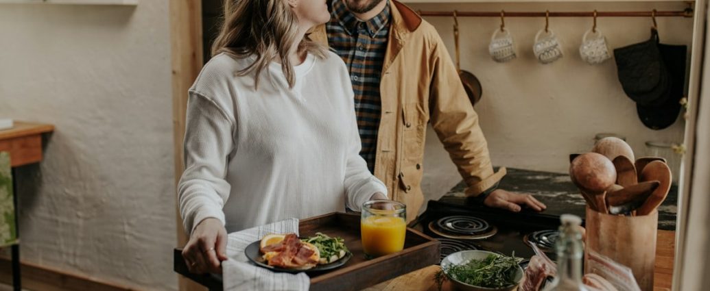 woman in white long sleeve shirt sitting on chair in front of table with foods